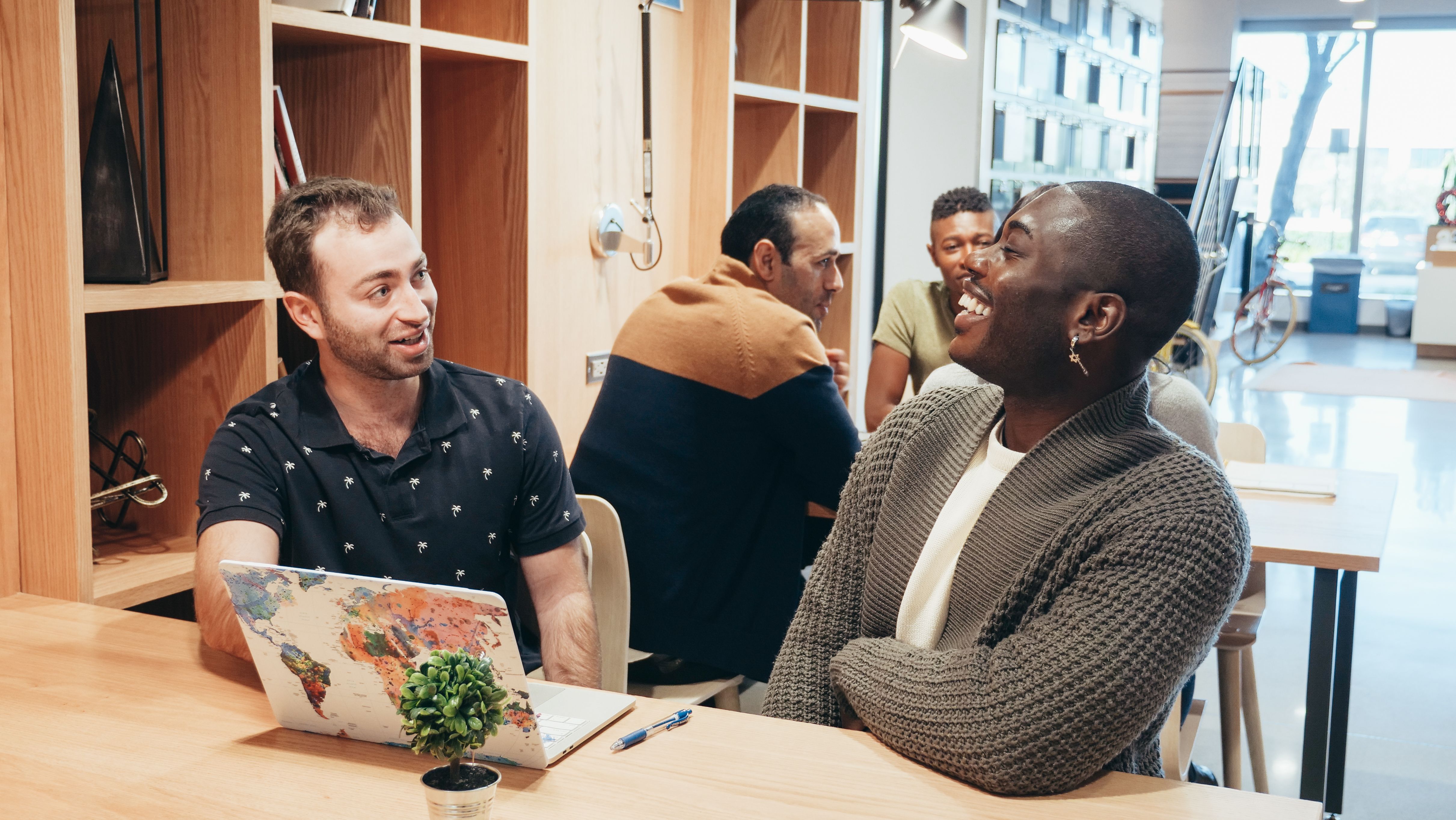 Colleagues in a lively discussion at a contemporary coworking space