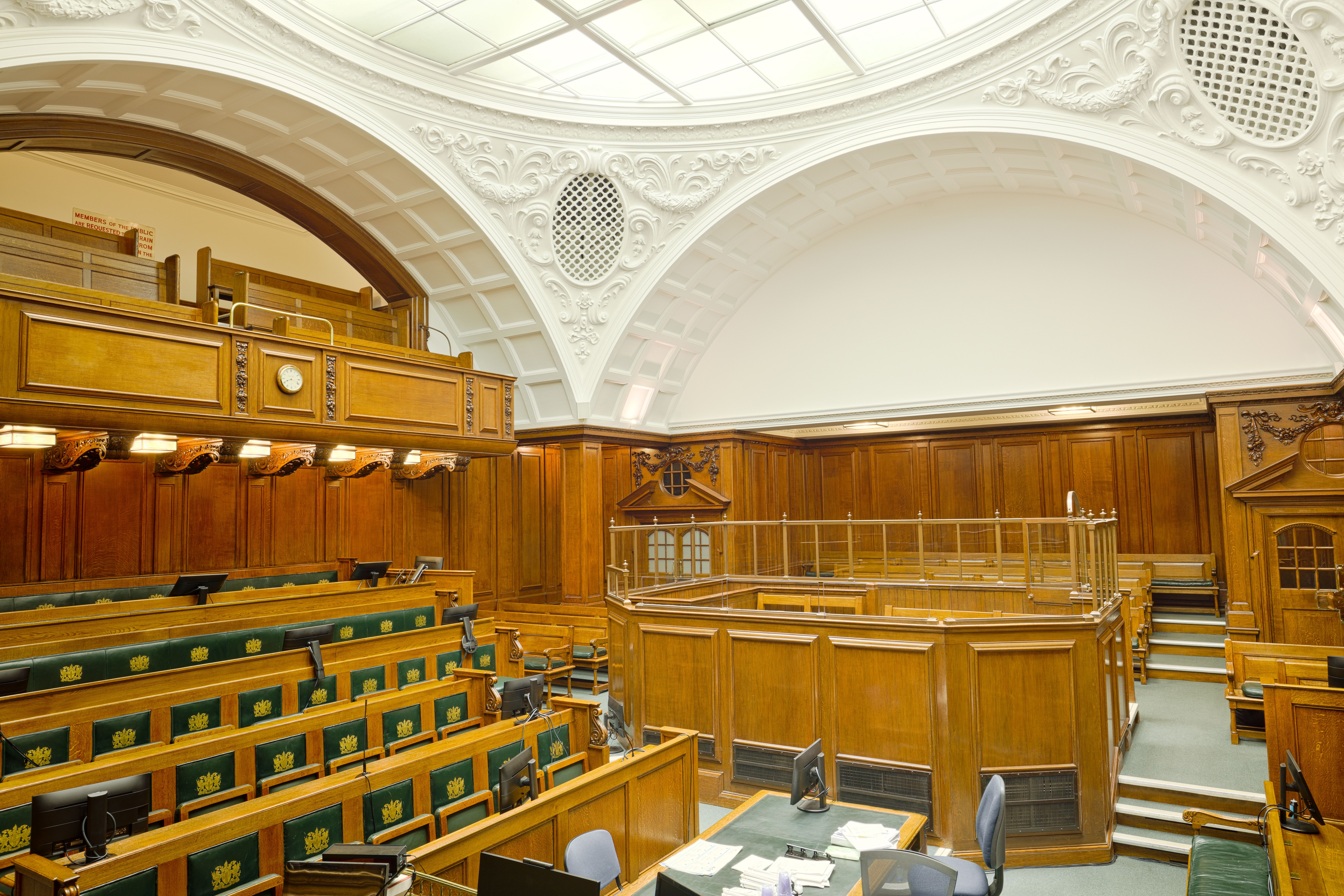 Interior view of a historic ornate courtroom in London with wooden furnishings