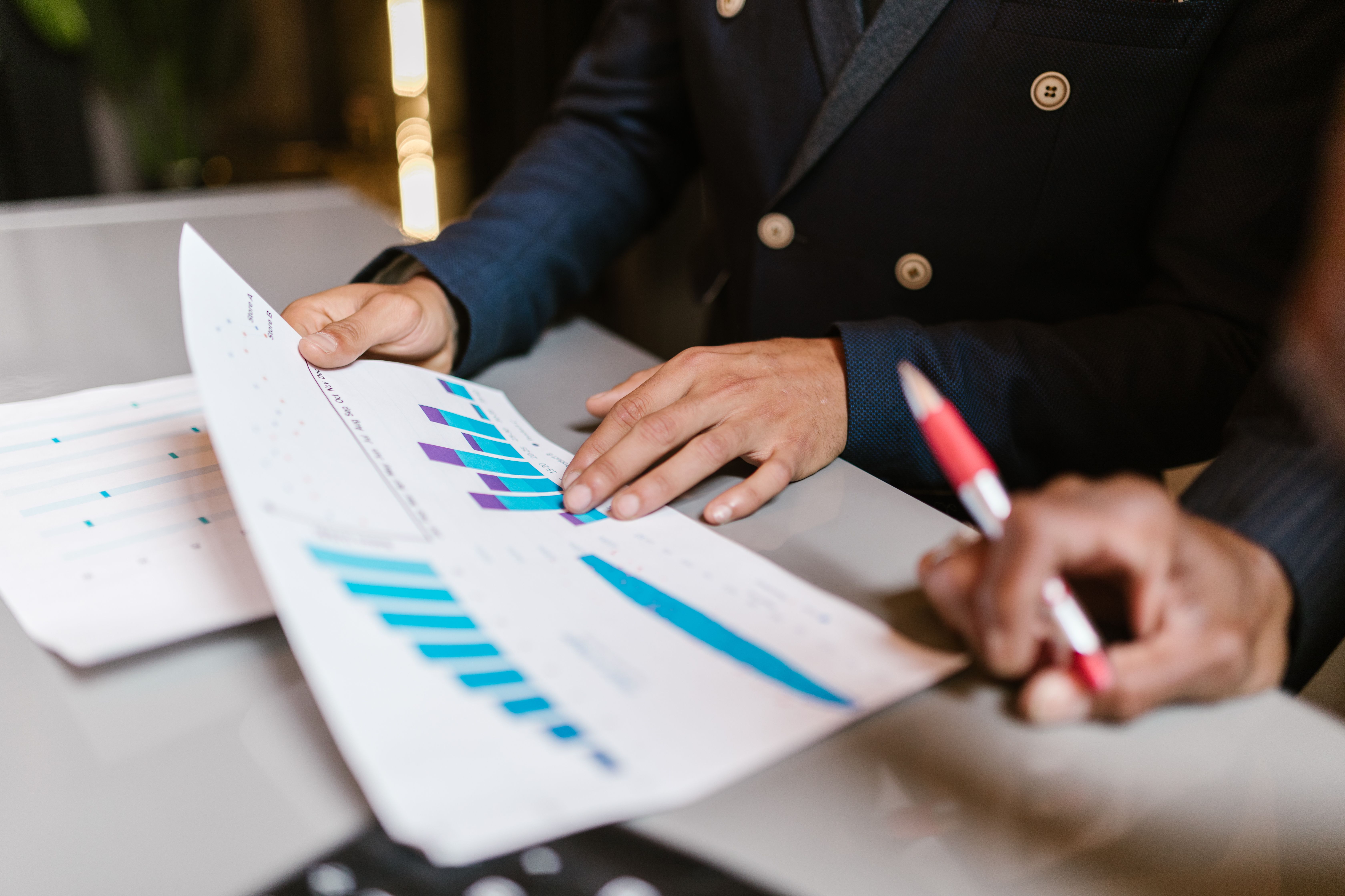 Professionals reviewing financial graphs to evaluate organizational performance