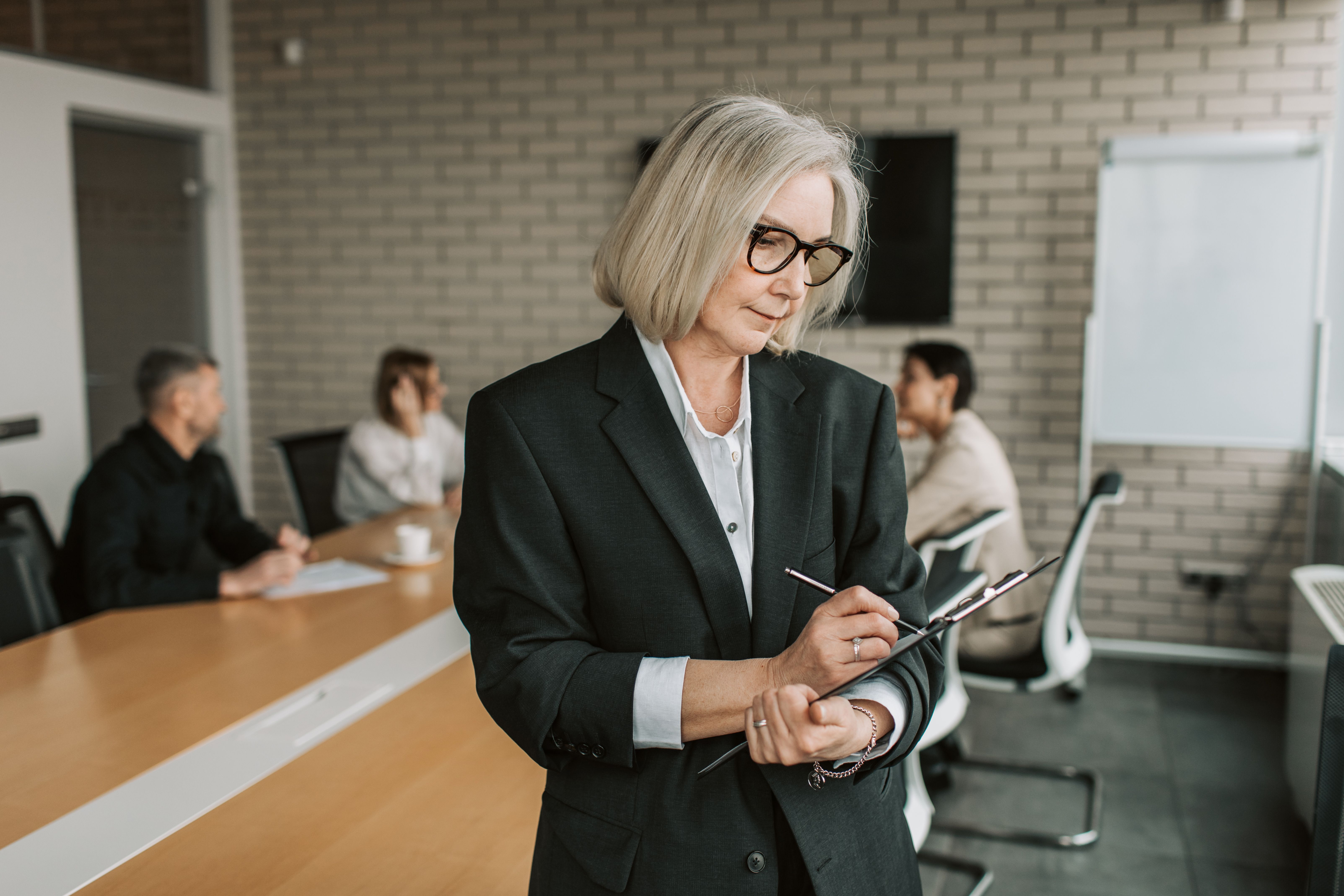 Senior businesswoman leading a team meeting in a modern office