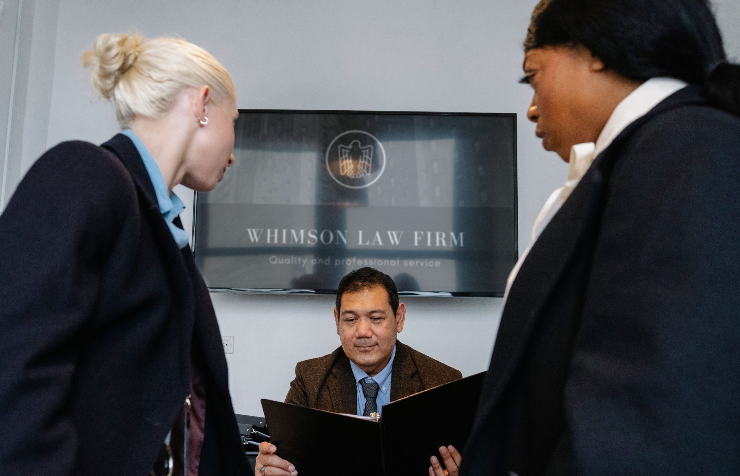 Diverse law firm colleagues reviewing a contract together in a conference room