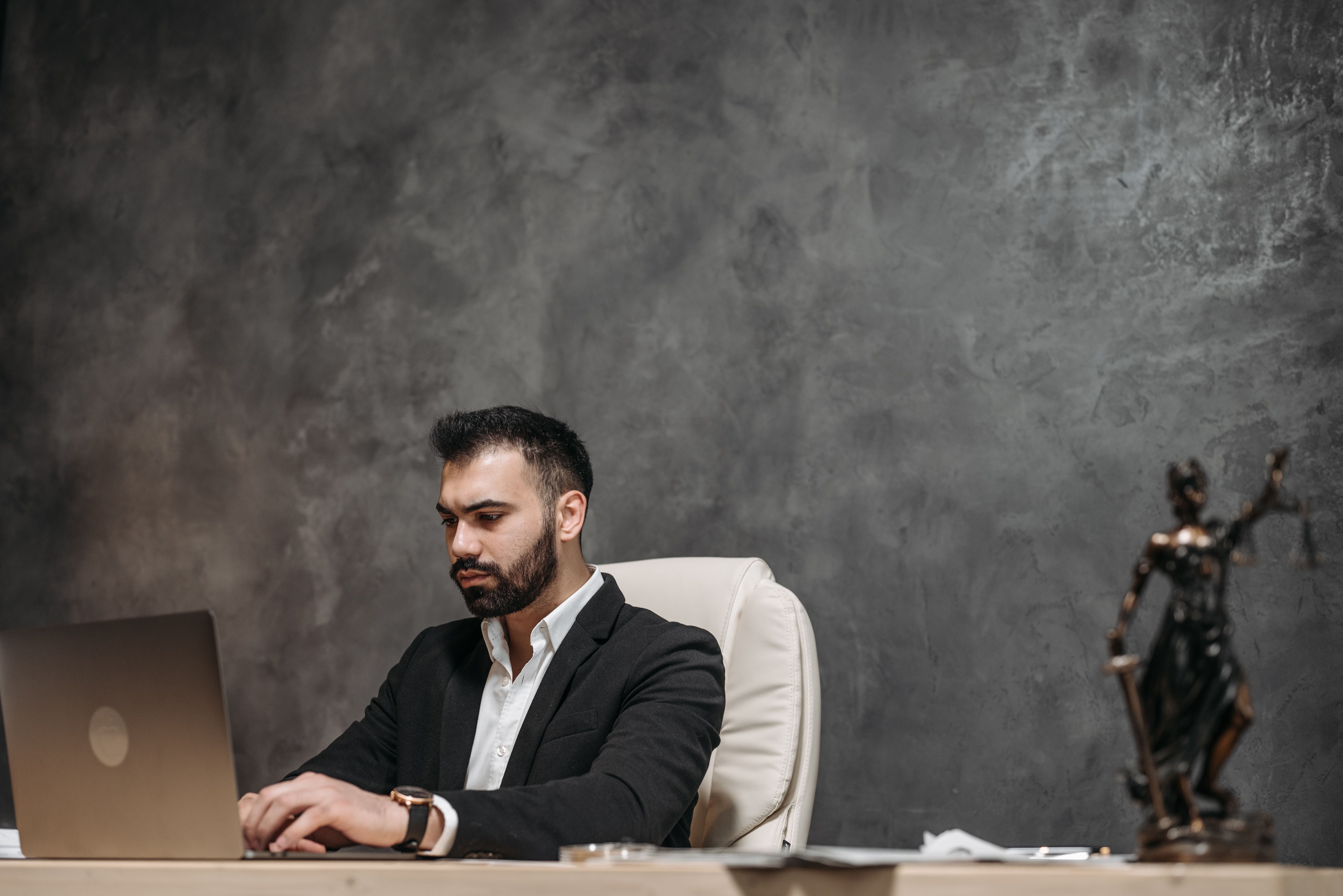 Focused professional man in an office working on a laptop